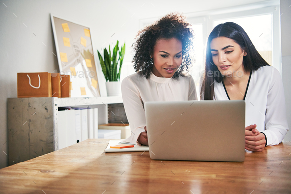 Two hardworking young business colleagues - Stock Photo - Images
