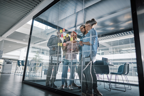 Diverse businesspeople having a brainstorming session in an office boardroom - Stock Photo - Images