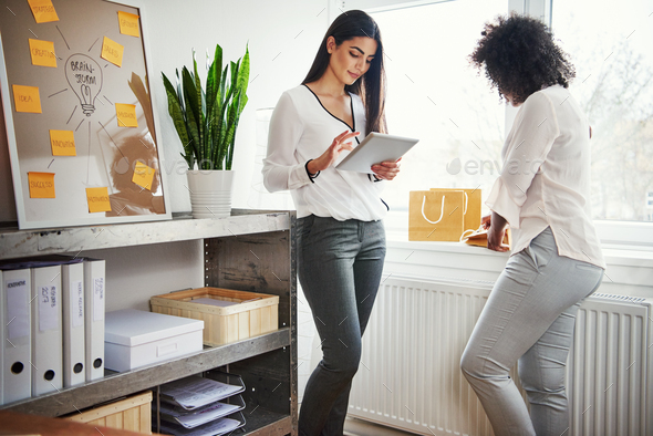 Two young women working on a packaging design - Stock Photo - Images