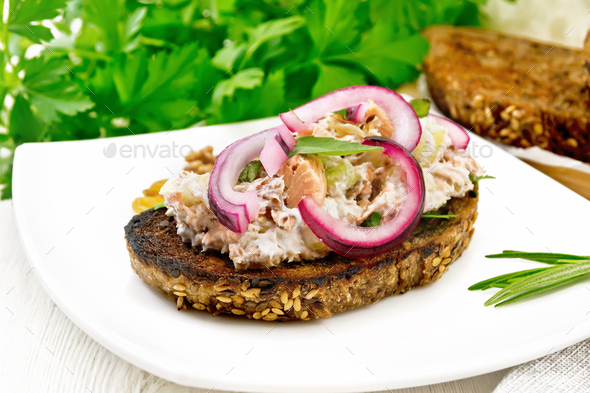 Bruschetta with fish and curd in plate on board - Stock Photo - Images