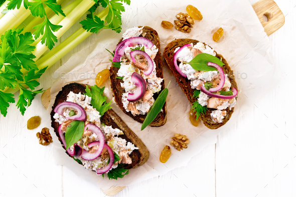 Bruschetta with fish and curd on light board top - Stock Photo - Images