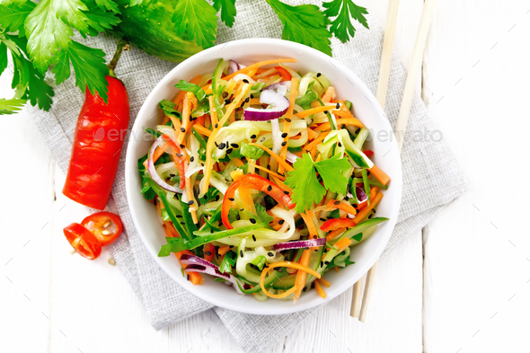 Salad of cucumber in bowl on light board top - Stock Photo - Images