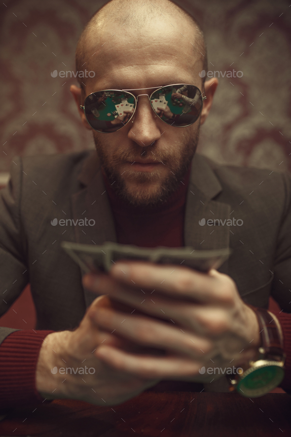 Professional poker player playing in casino - Stock Photo - Images