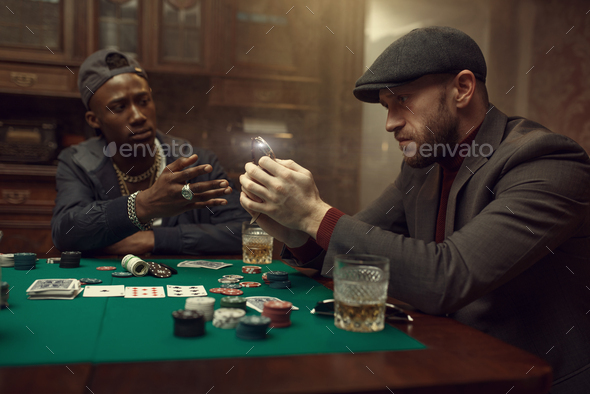 Poker player puts his wristwatch on the bank - Stock Photo - Images