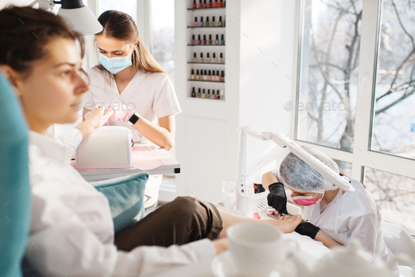 Two women on pedicure procedure in beauty salon - Stock Photo - Images