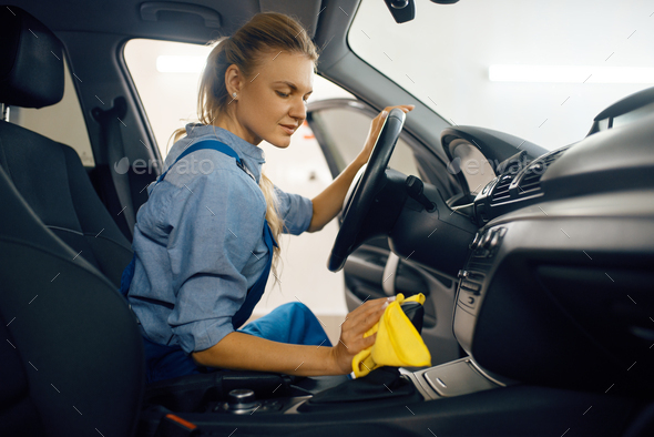 Female washer cleans automobile door trim - Stock Photo - Images