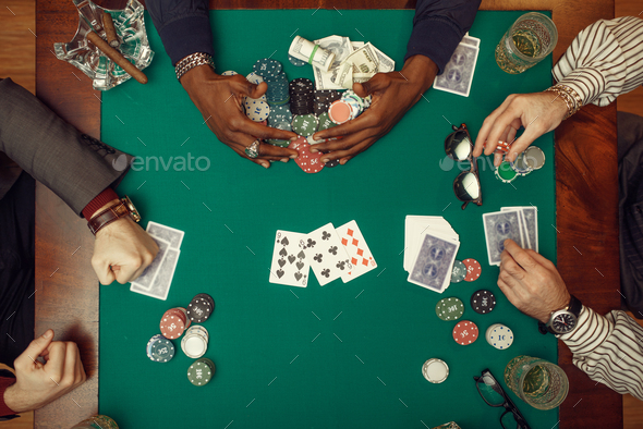 A top down view on a table with some poker cards on it