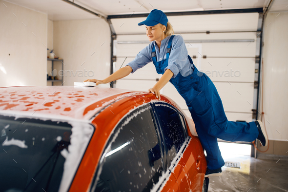 Female washer wipes the automobile windshield - Stock Photo - Images