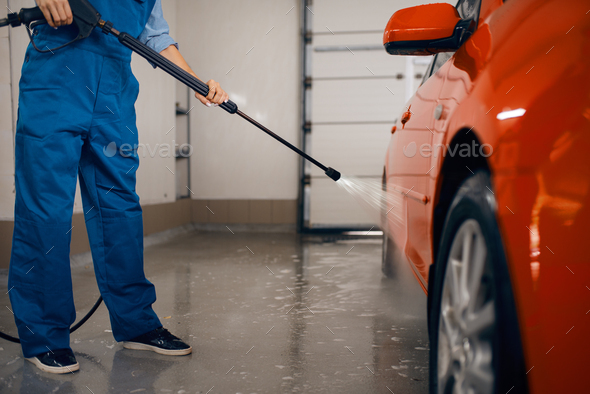 Female washer with high pressure gun, car wash - Stock Photo - Images