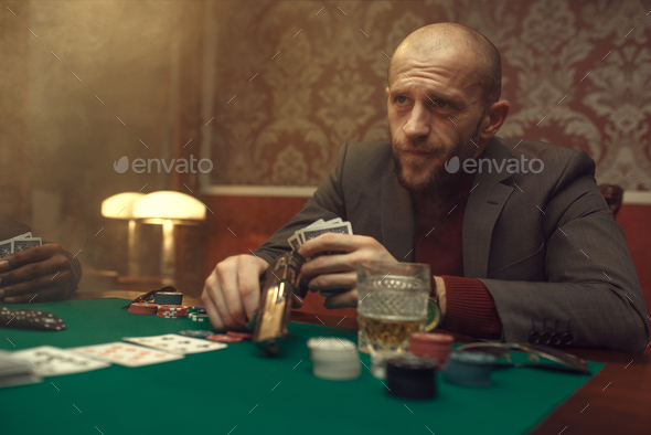 Poker player with gun plays in casino, risk - Stock Photo - Images