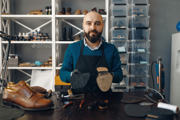 Bootmaker repairing the shoe, footwear repair - Stock Photo - Images