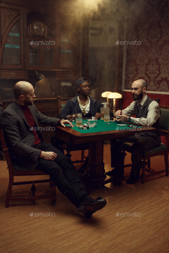 Poker players with cards and chips in casino - Stock Photo - Images