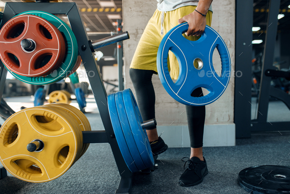 Male person doing exercise with wights in gym - Stock Photo - Images