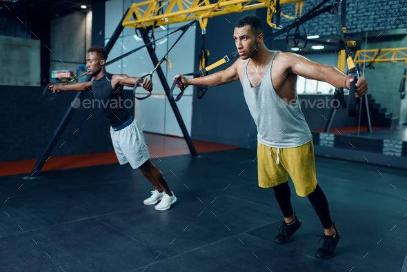 Two athletes at stretching exercise machine - Stock Photo - Images