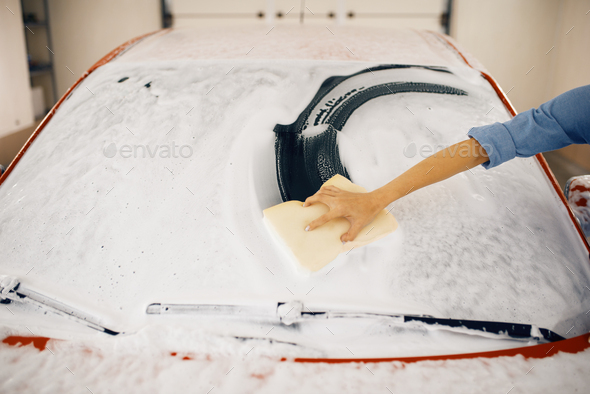 Female washer wipes the automobile windshield - Stock Photo - Images