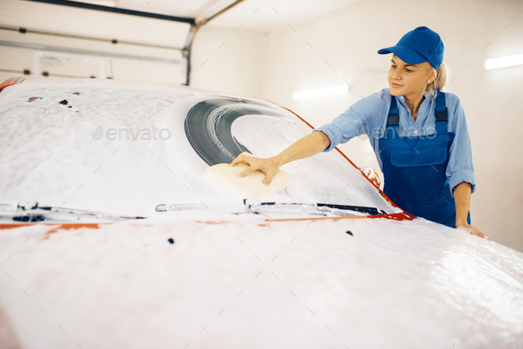 Female washer wipes the automobile windshield - Stock Photo - Images