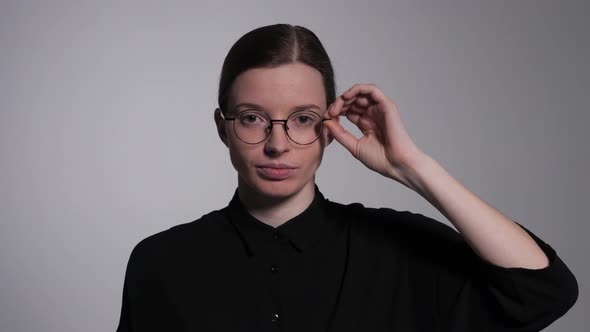 Student Adjusts Glasses