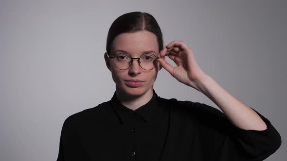 Student Adjusts Glasses alt