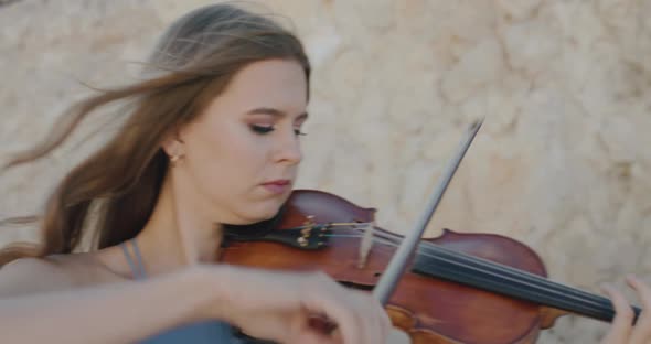 Female Musicians in Dresses Play Viola Take Turns on Camera at Cliff in Summer alt