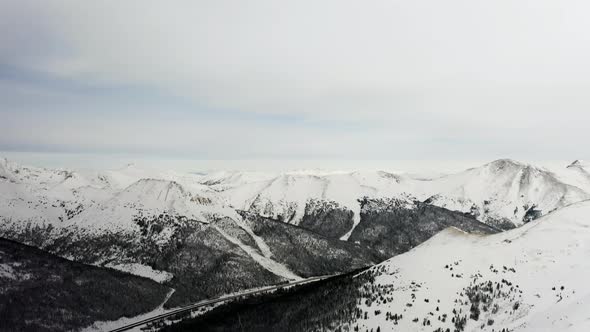  4k view above the Rocky Mountains and snow covered Arapaho and Roosevelt National Forests  alt