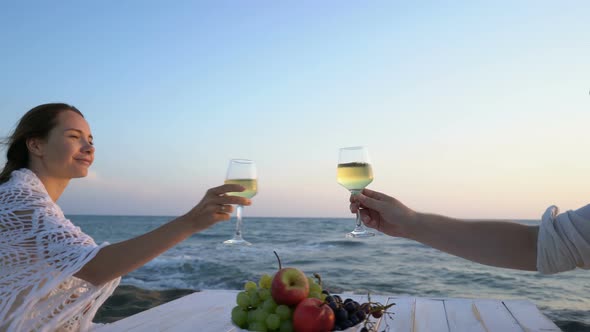 Attractive Couple By the Sea with Wine and Fruit Enjoying Each Other's Company