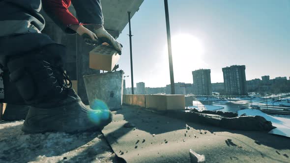 Brick Wall Is Getting Built in a Multistory Residential House alt