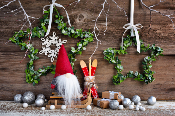 Christmas composition with a gnome on sleigh and festive decorations - Stock Photo - Images