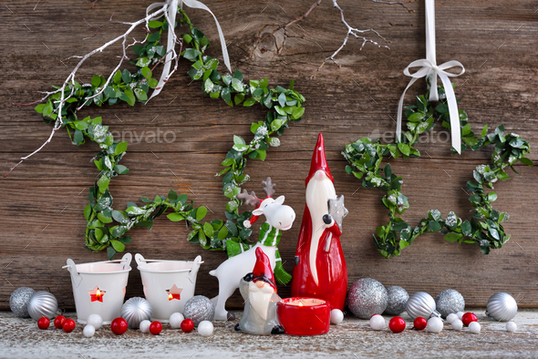 Christmas composition with gnomes, elk figurine and festive decorations on wooden background - Stock Photo - Images