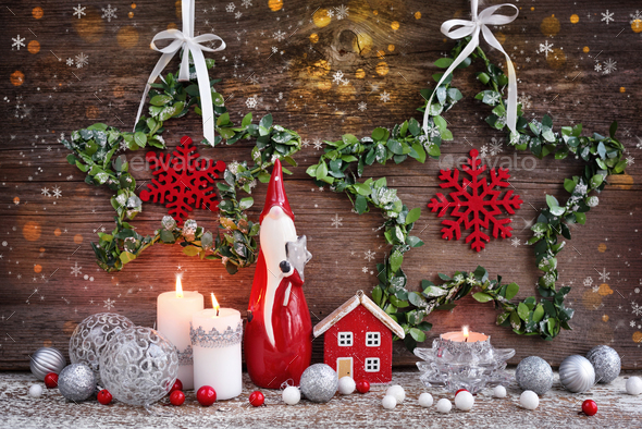Christmas composition with candles, gnome figurine, photo frame and festive decorations - Stock Photo - Images