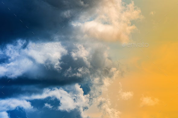 Dramatic Blue Thunderclouds, Stunning Yellow-Golden Fluffy Clouds Illuminated by Rays of Sun - Stock Photo - Images