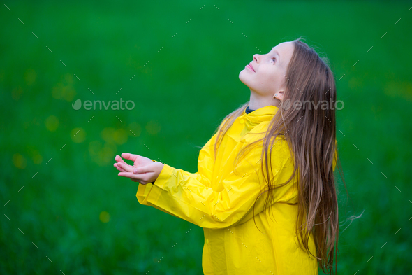 Little girl deals in raincoat