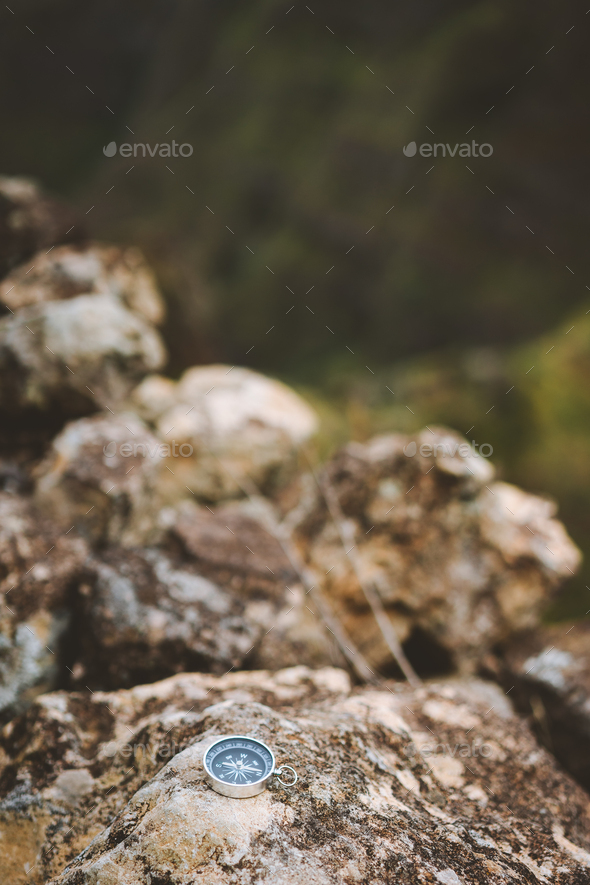 Navigation concept - Analogical compass laying on the rocky stone during trekking route in mountains - Stock Photo - Images