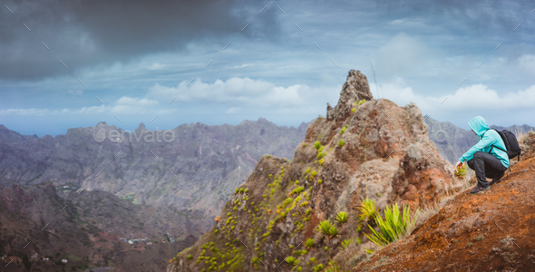 Woman hiker with backpack going down a sand dune towards the lonely beach. Sao Vicente Cape Verde - Stock Photo - Images