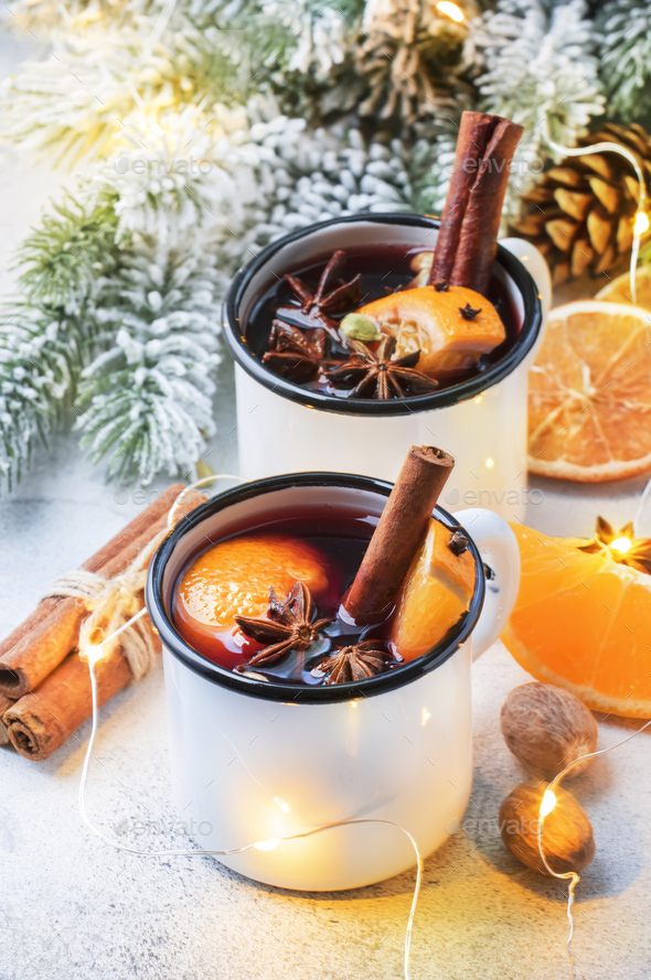 Mulled wine in white metal mugs - Stock Photo - Images