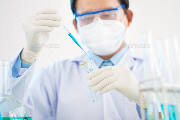 Talented Researcher Carrying out Experiment - Stock Photo - Images