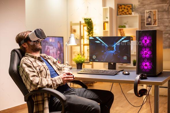 Professional gamer man using VR headset to play on powerful PC - Stock Photo - Images