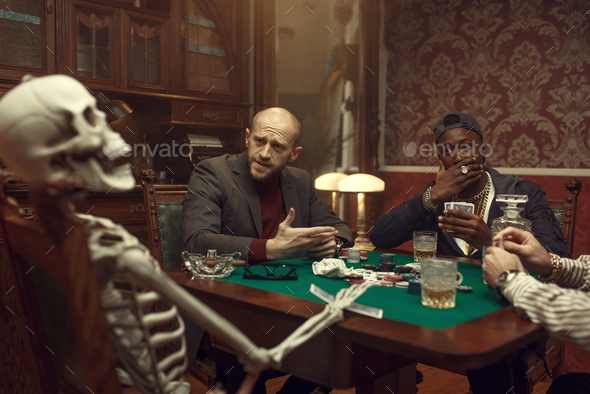 Poker players and skeleton at gaming table, fun - Stock Photo - Images