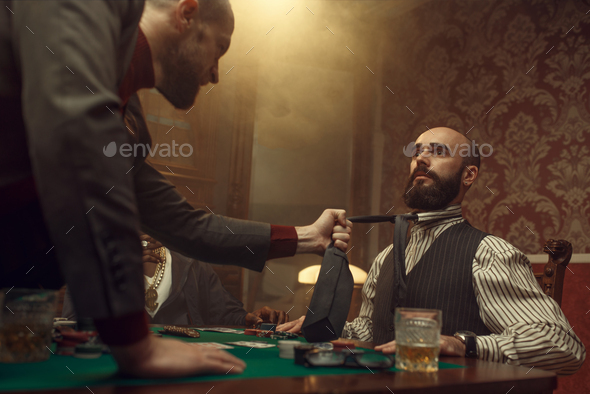 Poker player grabbed his opponent's tie, casino - Stock Photo - Images
