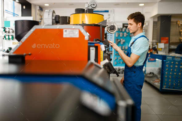 Plumber choosing boiler with furnace, plumbering - Stock Photo - Images