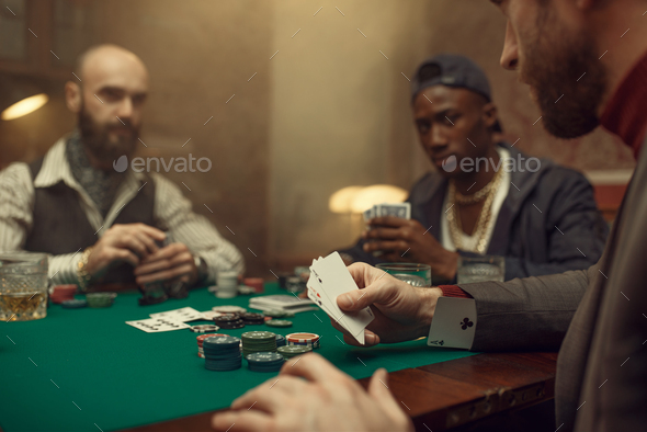 Male player cheating in poker - Stock Photo - Images