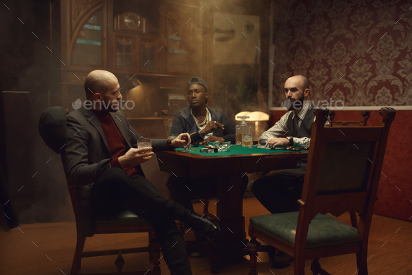 Poker players with cards and chips in casino - Stock Photo - Images