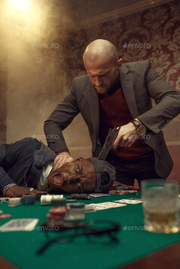Poker player with gun, showdown with opponents - Stock Photo - Images