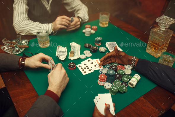 Male poker players at gaming table, casino - Stock Photo - Images