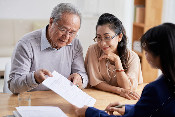 Studying Real Estate Purchase Agreement - Stock Photo - Images