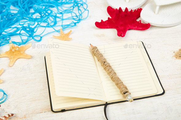 Notebook, starfishes and seashells, glass with sand - Stock Photo - Images