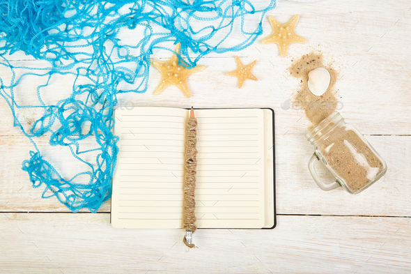 Notebook, starfishes and seashells, glass with sand - Stock Photo - Images