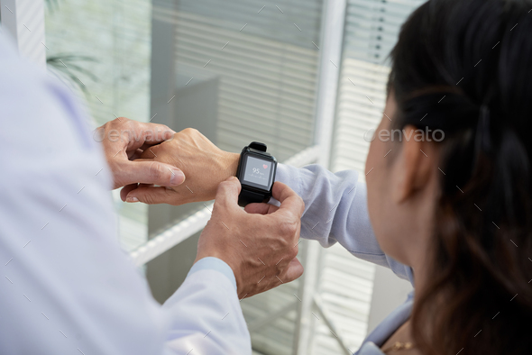 Checking Heart Rate with Smartwatch - Stock Photo - Images