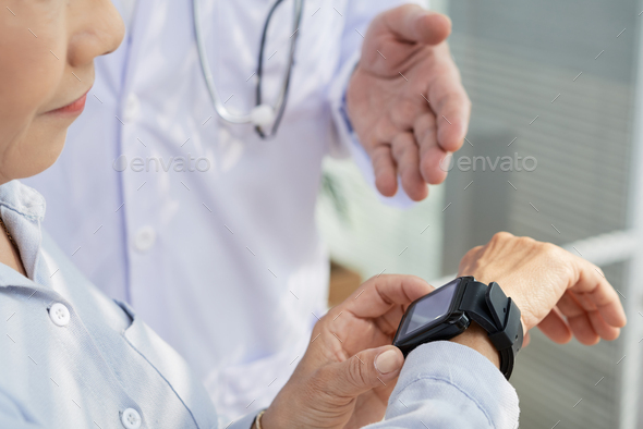 Female Patient Using Smartwatch - Stock Photo - Images
