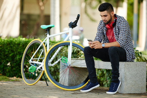 Handsome Cyclist Using Smartphone - Stock Photo - Images