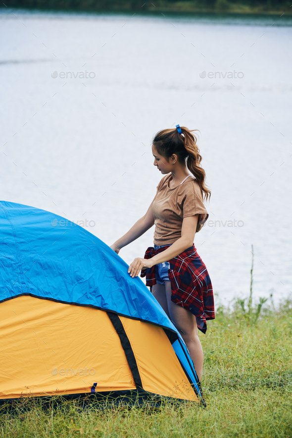 Pretty Woman Setting up Tent - Stock Photo - Images